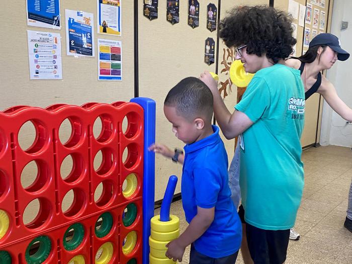 Penn State DuBois student Melakai Forrest interacts with a school-aged child at the Boys and Girls Club of Puerto Rico during the alternative spring break trip.